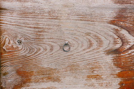 Engagement ring for the bride on an old wooden board.の写真素材