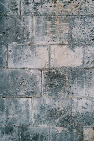 Scratched texture of gray concrete wall made of massive slabs.の写真素材