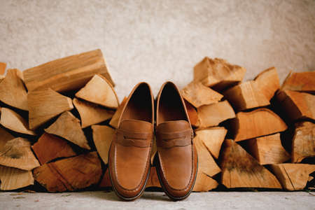 Brown mens shoes Penny loafers at the wood logs for the firebox.の写真素材