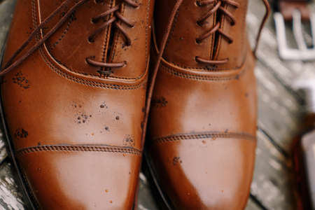 Close-up of brown mens oxford shoes with raindrops.の写真素材