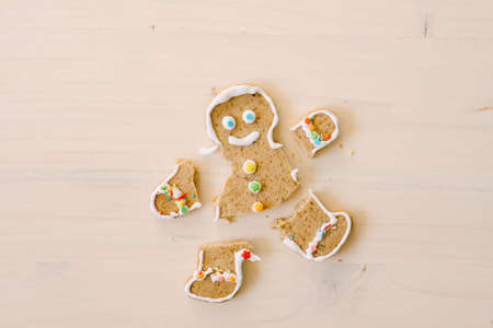 Gingerbread man with severed legs and arms. The limbs of the cookie are separated from the body....