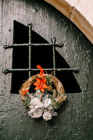 Christmas wreath on a metal door with old paint.の写真素材