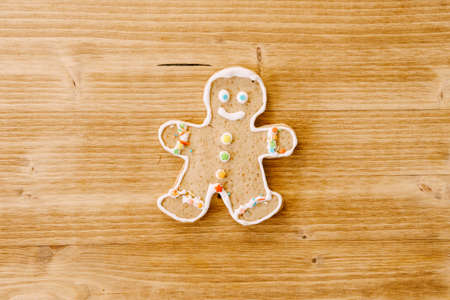 Christmas cookies gingerbread man on a wooden texture.の写真素材