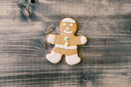 Christmas cookies gingerbread man on a wooden texture.の写真素材