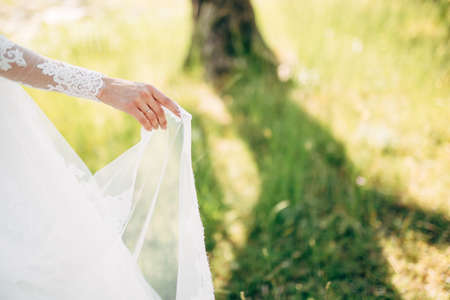 bride holding the edge of the veil in her hand