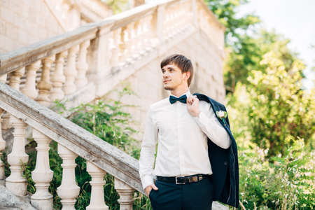 groom on the stairs of the Nativity of the Blessed Virgin Mary church in Prcanjの写真素材