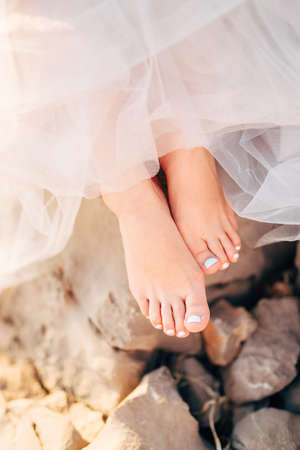 the brides bare feet peek out from under the lush skirtsの写真素材