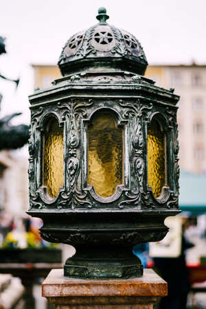 Large street lamp with a metal body in patterns with yellow glass.の写真素材