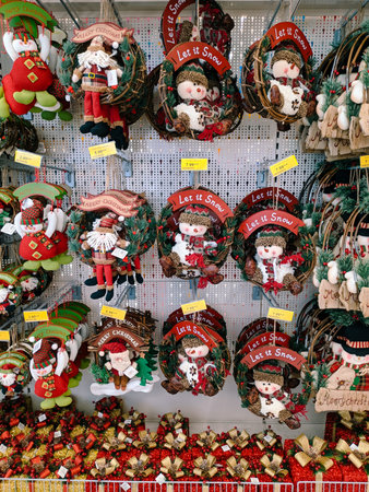 Budva, Montenegro - 15 December 2020: Christmas decorations on a showcase in a supermarket - Christmas wreath with a snowman and Santa Claus.のeditorial素材