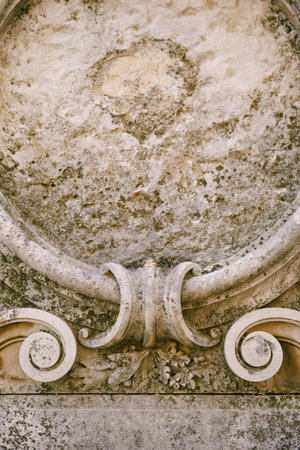 Close-up of gray stone bas-relief texture with gold rings of the bride and groom.の写真素材