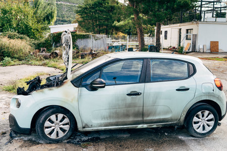 Budva, Montenegro - 17 march 2021: Citroen C3 2016 passenger car burnt out and extinguished by firefighters. Wiring under the hood caught fire.のeditorial素材