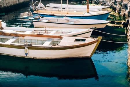 Close-up of boats tied with a rope at the pier.の写真素材