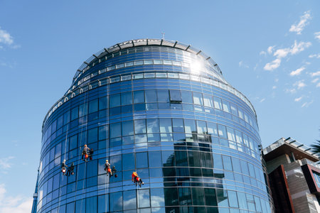 Industrial climbers are cleaning the windows of the building from the outside.の写真素材