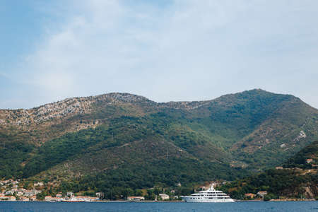 A large multi-deck white private yacht sails on the Bay of Kotor in Montenegro. The concept of the rich life of millionaires.の写真素材