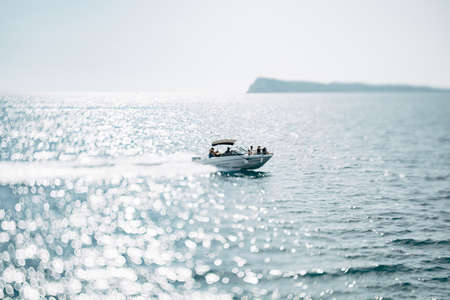 People sail on a white motor yacht in the open sea on a bright sunny dayの写真素材