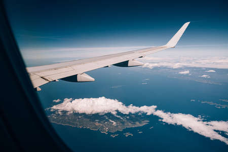 View from the airplane through the clouds over the coast of Croatiaの写真素材