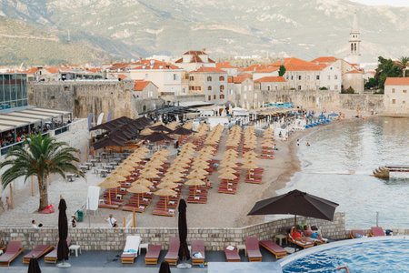 View of the small beach of the old town of Budva, Montenegro against the backdrop of green...