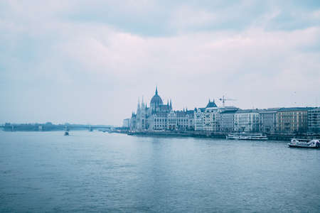 Great view of the parliament building, shrouded in haze, at dusk in Budapestの写真素材