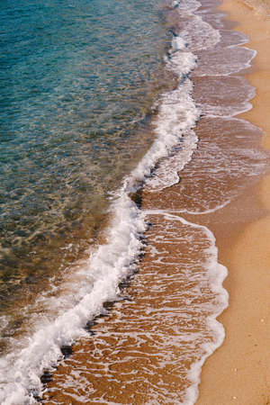 Sea waves on the background of a sandy beach. Side viewの写真素材