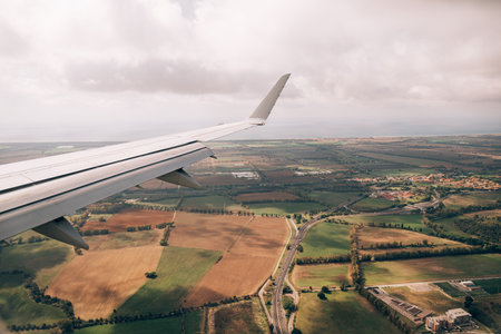 View from the airplane window of the fields and greenery belowの写真素材