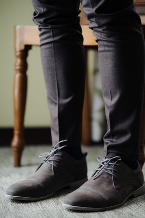 Groom feet close up in laced up shoesの写真素材