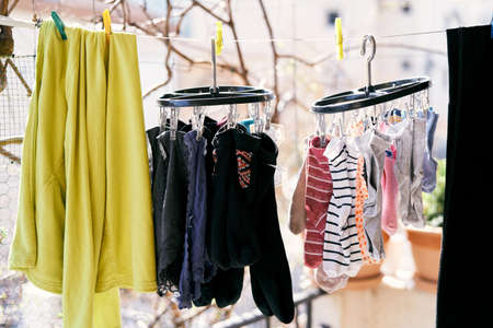 Drying clothes on a rope - jacket, socks and underpants. Close-upの写真素材