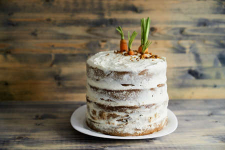 Carrot cake with cream cheese on a tableの写真素材