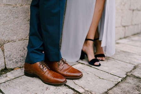 Legs of the bride and groom in wedding shoes. Close-upの写真素材