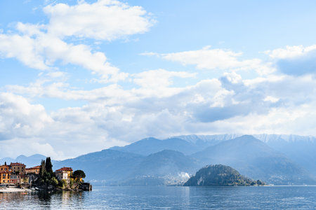 Coast of the town of Varenna against the backdrop of mountains and blue sky. Como, Italyの写真素材