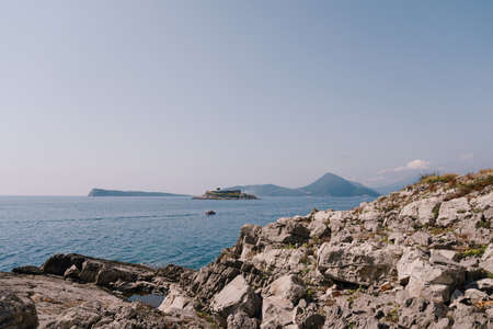View from the stony coast of Montenegro to the Mamula islandの写真素材