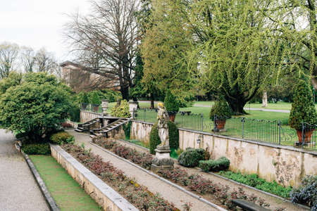 Statues among bushes and trees in the garden of Villa Trivulzio. Lake Como, Italy