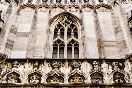 Arched window with marble frame on the facade of the Duomo. Italy, Milanの写真素材