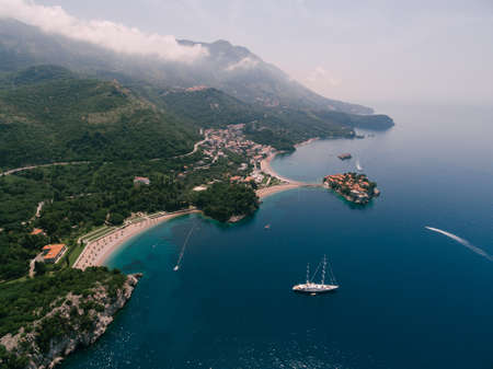 Sailboat sails along the bay to the royal beach. Villa Milocer, Montenegroの写真素材