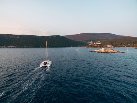 Yacht is sailing to the island of Otocic Gospa. Montenegroの写真素材