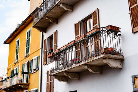Flowerpots on the balconies of the old houses of Varenna. Lake Como, Italy