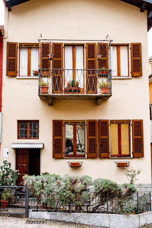 Flower bed with bushes at the doorstep of Varenna old house. Como, Italyの写真素材