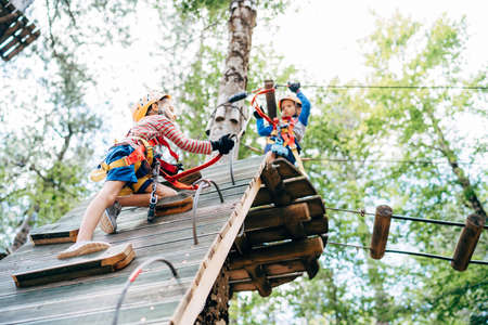 Boy climbing a climbing wall by rearranging carabinersの写真素材