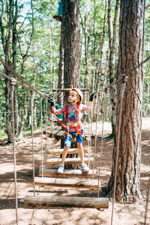 Boy stands on the agility bridge and looks up