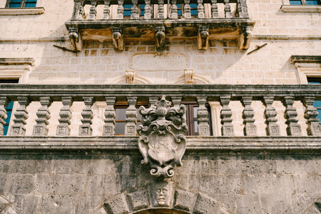 Balustrade of an old building with a coat of arms on the wall. Perast, Montenegroの写真素材