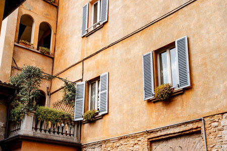 Old cozy house with flowers on the balcony and windows. Bergamo, Italyの写真素材