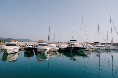 Boats are at the pier at the Lustica Bay. Montenegro