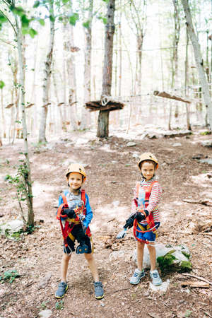 Boys are standing on the ground in an adventure parkの写真素材
