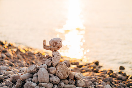 Stones stacked on top of each other by the seaの写真素材