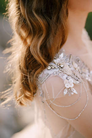 Bride shoulder in a sequin and beaded tulle dress. Close-upの写真素材
