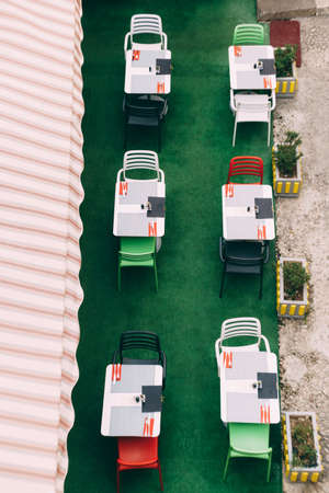 Top view of tables with chairs in a street cafe