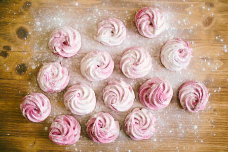 Pink marshmallow with powdered sugar on the table
