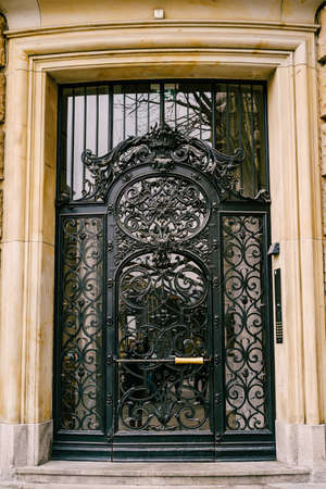 Forged door with glass inserts on the facade of a marble buildingの写真素材