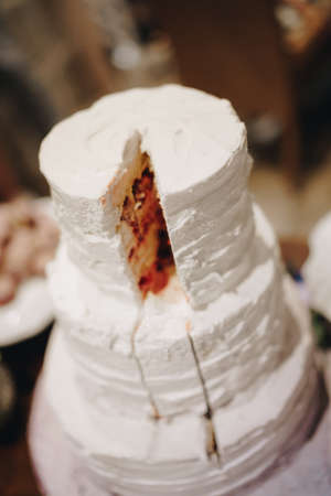 Cut white three-tiered wedding cake. Top viewの写真素材