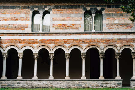 Arched corridor of an old brick house with columnsの写真素材