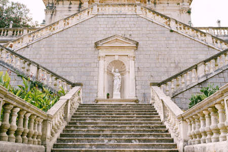 Statue of Christ in a niche at the steps near the Church of the Nativity of the Virgin in Prcanjの写真素材